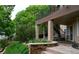 Landscaped patio and backyard featuring a lush garden and an outdoor seating area under the second story balcony at 2819 Canyon Crest Dr, Highlands Ranch, CO 80126