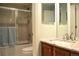Bathroom featuring neutral tile, glass shower doors, and granite countertops at 2819 Canyon Crest Dr, Highlands Ranch, CO 80126