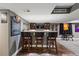 Basement wet bar area with seating, sports memorabilia, and stylish finishes at 16123 Quarry Hill Dr, Parker, CO 80134