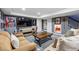 Basement living area with sofas, television, and unique wall decor at 16123 Quarry Hill Dr, Parker, CO 80134