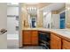 Bathroom with dual sinks, vanity, tile floor, shower, tub, and nice vanity lighting at 16123 Quarry Hill Dr, Parker, CO 80134