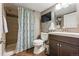Nicely appointed bathroom featuring stylish shower, dark wood vanity, and wood-look floors at 16123 Quarry Hill Dr, Parker, CO 80134