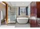 Beautiful bathroom showcasing a glass-enclosed shower and a modern tub surrounded by natural light at 16123 Quarry Hill Dr, Parker, CO 80134
