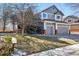 Charming two-story home featuring a well-manicured lawn and a two-car garage at 16123 Quarry Hill Dr, Parker, CO 80134