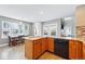 Bright kitchen featuring an island, wooden cabinets, modern appliances, and eat-in dining area at 16123 Quarry Hill Dr, Parker, CO 80134