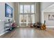 Spacious living room with hardwood floors, tall windows, and stylish decor at 16123 Quarry Hill Dr, Parker, CO 80134
