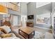Inviting living room with a fireplace, large windows, and open access to the kitchen at 16123 Quarry Hill Dr, Parker, CO 80134