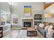 Bright living room with a stone fireplace, large windows, and a comfortable seating area at 16123 Quarry Hill Dr, Parker, CO 80134