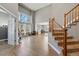 Bright living room with hardwood floors, a soaring ceiling, and large windows at 16123 Quarry Hill Dr, Parker, CO 80134