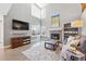 Open living room featuring a stone fireplace, a media center, and natural light from large windows at 16123 Quarry Hill Dr, Parker, CO 80134