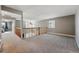 Spacious loft area featuring soft carpet, a ceiling fan, natural lighting and an ornate wooden railing at 16123 Quarry Hill Dr, Parker, CO 80134