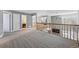 Carpeted loft area showcasing natural light, an office space, and views of the staircase and living room below at 16123 Quarry Hill Dr, Parker, CO 80134
