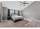 Light-filled main bedroom features vaulted ceilings, ceiling fan, carpet floors, and soft gray paint at 16123 Quarry Hill Dr, Parker, CO 80134