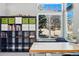 Bright office with large windows, neutral carpet, and black shelving unit at 16123 Quarry Hill Dr, Parker, CO 80134