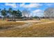 Community park featuring a sandy play area, mature trees, and inviting open space at 16123 Quarry Hill Dr, Parker, CO 80134