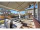 Covered patio with outdoor seating and a grill, perfect for enjoying the backyard at 16123 Quarry Hill Dr, Parker, CO 80134