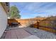 Backyard featuring brick and rock landscaping, wood fence, and dining table at 8300 S Upham Way, Littleton, CO 80128