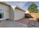 Backyard with a brick patio, landscaping with wood fence, and an exterior door at 8300 S Upham Way, Littleton, CO 80128