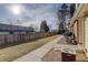 Private fenced backyard with a well-manicured lawn and a row of air conditioning units at 8300 S Upham Way, Littleton, CO 80128