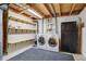 Unfinished basement area featuring a washer and dryer, fridge, and storage shelves at 8300 S Upham Way, Littleton, CO 80128