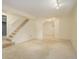 Large finished basement featuring carpet flooring, ample lighting, and staircase to upstairs at 8300 S Upham Way, Littleton, CO 80128