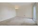 Large bedroom with neutral carpet, sliding glass doors to a patio, and natural light at 8300 S Upham Way, Littleton, CO 80128