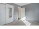 Bright bedroom featuring plush carpet, a mirrored sliding closet, and fresh neutral paint at 8300 S Upham Way, Littleton, CO 80128