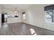 Inviting living room featuring wood-look floors, a ceiling fan, and a pass-through window to the kitchen at 8300 S Upham Way, Littleton, CO 80128