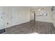 Open-concept living room with luxury vinyl floors, a ceiling fan, and ample space at 8300 S Upham Way, Littleton, CO 80128