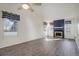 Spacious living room with a fireplace, ceiling fan, and large windows at 8300 S Upham Way, Littleton, CO 80128