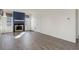 Bright living room featuring luxury vinyl floors, a fireplace, and plenty of natural light at 8300 S Upham Way, Littleton, CO 80128