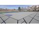 Two tennis courts in a fenced in area. One court has a basketball hoop at 8300 S Upham Way, Littleton, CO 80128