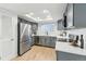 Modern kitchen featuring grey cabinetry, stainless steel appliances, and ample counter space at 9055 Holland St, Broomfield, CO 80021