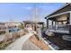 Landscaped backyard featuring a pergola, patio, and outdoor seating area, perfect for relaxation and entertaining at 7899 S Country Club Pkwy, Aurora, CO 80016