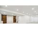 Spacious finished basement with recessed lighting, storage and barn doors at 7899 S Country Club Pkwy, Aurora, CO 80016