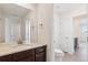 Bright bathroom showcasing a vanity with granite countertops, tile floors, and a toilet at 7899 S Country Club Pkwy, Aurora, CO 80016