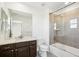 Well-lit bathroom featuring a granite countertop, shower, and vanity at 7899 S Country Club Pkwy, Aurora, CO 80016