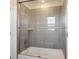 Bathroom featuring gray tile shower with a glass door and chrome fixtures at 7899 S Country Club Pkwy, Aurora, CO 80016