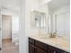Bathroom featuring tile floors, double mirrors, granite counters, and white cabinets at 7899 S Country Club Pkwy, Aurora, CO 80016