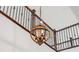 Close up shot of a wooden light fixture with rod iron railing in background at 7899 S Country Club Pkwy, Aurora, CO 80016