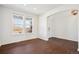 Bright, open room with hardwood floors, two windows and a front door view at 7899 S Country Club Pkwy, Aurora, CO 80016