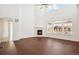 Bright living room featuring high ceilings, large windows, and a cozy fireplace at 7899 S Country Club Pkwy, Aurora, CO 80016