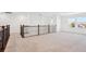 Bright loft area with neutral carpeting and decorative wrought iron railing at 7899 S Country Club Pkwy, Aurora, CO 80016