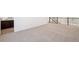 Neutral carpeted loft area with views towards a bathroom and staircase at 7899 S Country Club Pkwy, Aurora, CO 80016