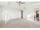 Spacious main bedroom featuring tray ceiling, neutral carpet, and access to en suite bathroom at 7899 S Country Club Pkwy, Aurora, CO 80016
