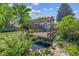 Backyard wooden deck and pergola overlooking a koi pond with green landscaping at 848 S 13Th Ave, Brighton, CO 80601