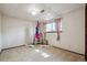 Finished basement bonus room with punching bag and window with curtains at 848 S 13Th Ave, Brighton, CO 80601