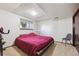 Finished basement bedroom with a red bed, window, and carpeting at 848 S 13Th Ave, Brighton, CO 80601