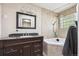 Bathroom with dark wood vanity, granite countertop, and a tub surrounded by ceramic tiles at 848 S 13Th Ave, Brighton, CO 80601