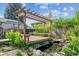Backyard wooden deck with a pergola and seating overlooking a koi pond at 848 S 13Th Ave, Brighton, CO 80601